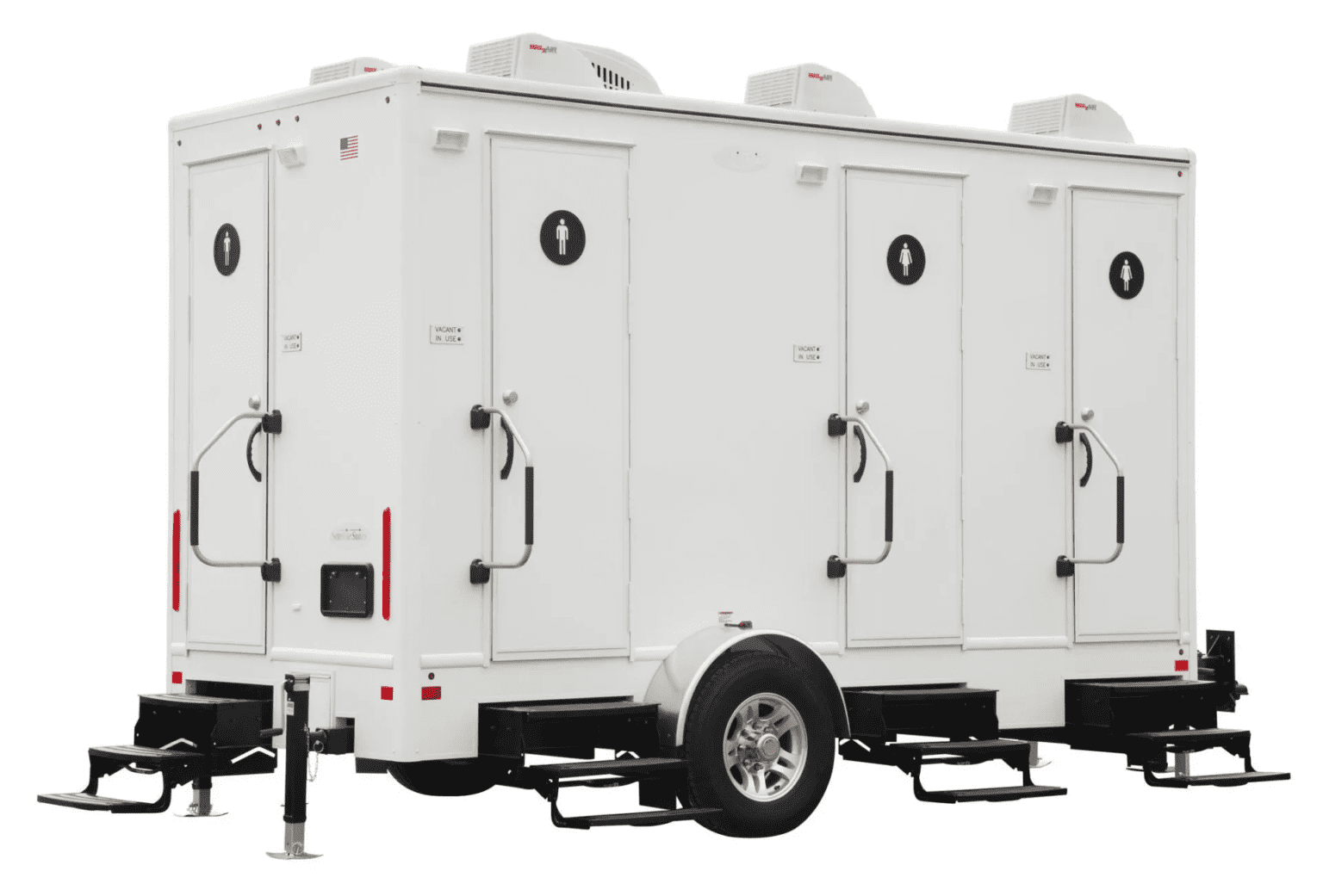 Four-stall restroom trailer with white paneled doors and modern design, parked on gravel for outdoor service.